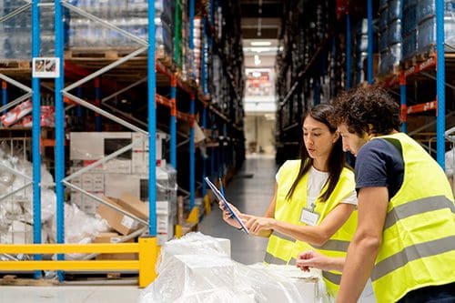Workers use a supply chain management tool.